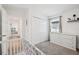 Bedroom with white dresser, closet, and white crib in front at 37820 Beacon Brick Dr, Zephyrhills, FL 33540