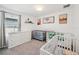 Cozy Bedroom with multiple cribs, neutral decor, and ample storage for a growing Gathering at 37820 Beacon Brick Dr, Zephyrhills, FL 33540