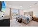 Spacious main bedroom suite with tufted headboard, neutral decor, and plush carpet at 37820 Beacon Brick Dr, Zephyrhills, FL 33540