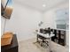 Bright home office with a modern desk, neutral tones, and a large window with natural light at 37820 Beacon Brick Dr, Zephyrhills, FL 33540