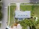 Aerial view showing screened-in pool and fenced yard in a well-maintained neighborhood at 410 N Corona Ave, Clearwater, FL 33765