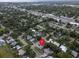 Aerial view pinpoints home in a neighborhood with mature trees and established homes at 410 N Corona Ave, Clearwater, FL 33765