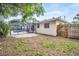 Spacious backyard with brick-paved area and screened-in lanai with a swimming pool at 410 N Corona Ave, Clearwater, FL 33765