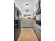 Well-lit kitchen features ample gray cabinetry, modern appliances, and a charming window view at 410 N Corona Ave, Clearwater, FL 33765