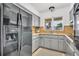 Bright and functional kitchen with ample gray cabinetry, modern appliances, and a convenient layout at 410 N Corona Ave, Clearwater, FL 33765