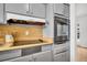 Efficient kitchen with light gray cabinets, and modern appliances at 410 N Corona Ave, Clearwater, FL 33765