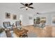 Bright living room with hardwood floors, ceiling fans, modern decor and a view to the dining area at 410 N Corona Ave, Clearwater, FL 33765