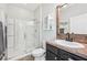 Well-lit bathroom features a glass-enclosed shower, vanity with sink, and tiled floor at 4151 Little Gap Loop, Ellenton, FL 34222