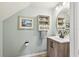Charming powder room with stylish vanity, decorative mirror, and coastal decor at 4151 Little Gap Loop, Ellenton, FL 34222