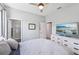 Bright bedroom with white dresser, TV, and en-suite bathroom with tiled shower at 4151 Little Gap Loop, Ellenton, FL 34222