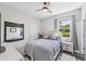 Comfortable bedroom with wood-look floors, neutral color scheme, and plenty of natural light at 4151 Little Gap Loop, Ellenton, FL 34222