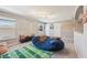 Large bonus room with plenty of natural light, football decor, and comfortable seating at 4151 Little Gap Loop, Ellenton, FL 34222