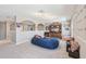 Spacious bonus room with comfortable seating, media center, and playful decor at 4151 Little Gap Loop, Ellenton, FL 34222
