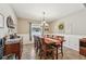 Traditional dining room featuring wainscoting and modern chandelier at 4151 Little Gap Loop, Ellenton, FL 34222
