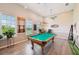 Well-lit game room featuring a pool table, hardwood floors, and neutral paint at 4151 Little Gap Loop, Ellenton, FL 34222