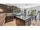 Stylish kitchen with island and bar seating featuring granite countertops at 4151 Little Gap Loop, Ellenton, FL 34222