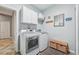 Convenient laundry room with modern washer and dryer, storage cabinets, and stylish decor at 4151 Little Gap Loop, Ellenton, FL 34222