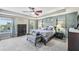 Inviting main bedroom features tray ceiling, accent wall, and seating area at 4151 Little Gap Loop, Ellenton, FL 34222