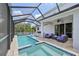 A covered pool area with a spa and built in grill at 4151 Little Gap Loop, Ellenton, FL 34222