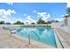 Community pool with clear blue water, surrounded by lounge chairs and a white fence at 4151 Little Gap Loop, Ellenton, FL 34222
