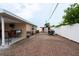Large backyard area featuring brick pavers, covered patio, and privacy fence at 4403 W Minnehaha St, Tampa, FL 33614