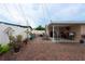 Large backyard area featuring brick pavers, covered patio, and privacy fence at 4403 W Minnehaha St, Tampa, FL 33614