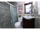 Bathroom featuring a glass-door shower, toilet, and sink with dark wooden vanity at 4403 W Minnehaha St, Tampa, FL 33614