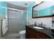 Well-lit bathroom with a glass-enclosed shower and a dark wood vanity at 4403 W Minnehaha St, Tampa, FL 33614
