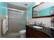 Well-lit bathroom with a glass-enclosed shower and a dark wood vanity at 4403 W Minnehaha St, Tampa, FL 33614