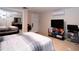Cozy bedroom featuring a mirrored closet, tile floor, and wall-mounted air conditioner at 4403 W Minnehaha St, Tampa, FL 33614