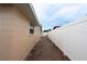 Side exterior view of house featuring brick pavers and privacy fence at 4403 W Minnehaha St, Tampa, FL 33614