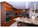 Stylish kitchen featuring custom wood cabinets, stainless steel appliances, and granite countertops at 4403 W Minnehaha St, Tampa, FL 33614