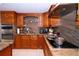 Close up view of a kitchen cooktop with stainless steel range hood at 4403 W Minnehaha St, Tampa, FL 33614