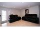 Inviting living room with black leather furniture, tile flooring, and recessed lighting at 4403 W Minnehaha St, Tampa, FL 33614