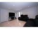 Living Room showing two black leather couches, TV, and a door at 4403 W Minnehaha St, Tampa, FL 33614