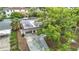 Aerial view of a home featuring mature trees, a carport, and a screened-in pool area at 4419 W El Prado Blvd, Tampa, FL 33629