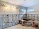 A bathroom featuring concrete block wall with a vanity area and a corner window at 4419 W El Prado Blvd, Tampa, FL 33629