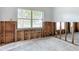 Bright living room featuring exposed wall frames ready for restoration, and large windows looking outdoors at 4419 W El Prado Blvd, Tampa, FL 33629