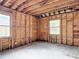 Room with exposed wall frames ready for remodel, showing structure, windows, and potential at 4419 W El Prado Blvd, Tampa, FL 33629