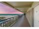 Balcony view of beach from condo hallway during a vibrant sunset at 4510 Gulf Blvd # 604, St Pete Beach, FL 33706