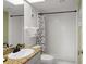 Bathroom featuring a shower, granite counters, and white tile at 4510 Gulf Blvd # 604, St Pete Beach, FL 33706