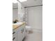 Bathroom featuring a shower, granite counters, and white tile at 4510 Gulf Blvd # 604, St Pete Beach, FL 33706