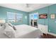 Bright main bedroom features beach views, balcony access, a ceiling fan, and a TV at 4510 Gulf Blvd # 604, St Pete Beach, FL 33706