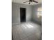 Bedroom with tile flooring, an open doorway, and a window at 5211 E 17Th Ave, Tampa, FL 33619