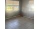 Bedroom featuring tile floors and a window allowing natural light at 5211 E 17Th Ave, Tampa, FL 33619