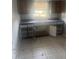 Functional kitchen featuring an open sink and unfinished cabinets at 5211 E 17Th Ave, Tampa, FL 33619