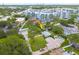 Aerial view of a home with a pool, surrounded by lush landscaping and modern apartment complexes in the distance at 5700 Pacific N St, St Petersburg, FL 33703