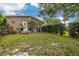 Lush backyard featuring well-maintained landscaping, potted plants, and a sun decoration on the home's exterior wall at 5700 Pacific N St, St Petersburg, FL 33703