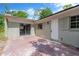 Outdoor patio featuring glass doors and a door leading to the backyard, offering a blend of indoor-outdoor space at 605 Ronele Dr, Brandon, FL 33511