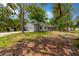 Exterior showcasing the home's side, garage, long driveway, and mature trees at 605 Ronele Dr, Brandon, FL 33511